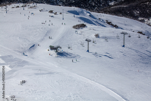 Aerial view of Mount Hotham ski resort with people skiing on snowy slopes, Victoria, Australia. photo