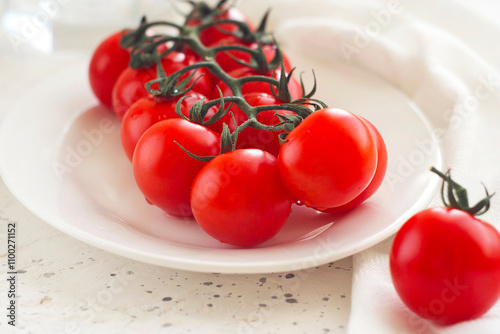 red cherry tomatoes lie in a plate on the table