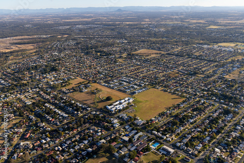 Aerial view of suburban homes and cityscape with a grid layout, Raceview, Queensland, Australia. photo