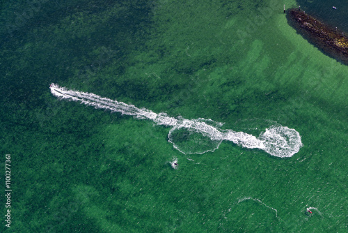 Aerial view of jetski creating dynamic waves on beautiful green water, St Leonards, Victoria, Australia. photo