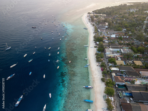 Aerial view of beautiful tropical beach with clear water and boats, Pemenang, Indonesia. photo