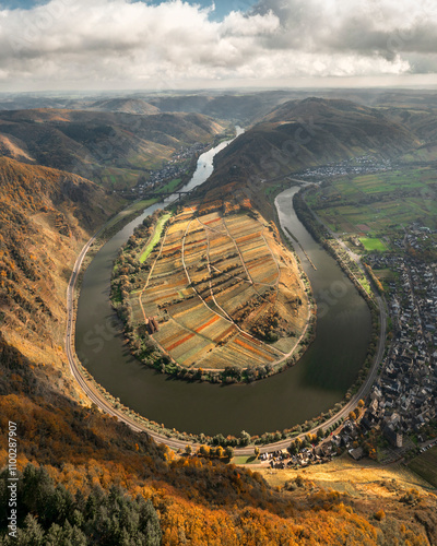 Aerial view of the meandering Mosel river with vessels and picturesque hills in autumn, Bremm, Rhineland-Palatinate, Germany. photo