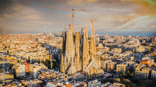 Aerial view of the beautiful Basilica de la Sagrada Familia surrounded by historic buildings and streets, Barcelona, Spain.