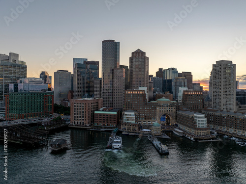 Aerial view of beautiful Boston skyline with modern buildings and boats at the dock during sunset, Boston, Massachusetts, United States. photo