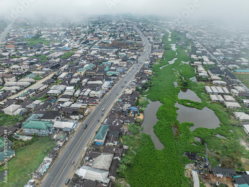 Aerial view of a vibrant cityscape with a lake surrounded by greenery and modern buildings, Yenegoa, Bayelsa, Nigeria. photo