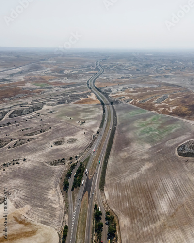 Aerial view of a beautiful desert landscape with a serene valley and winding road, La Almolda, Spain. photo