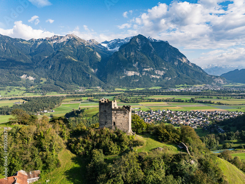 Aerial view of a picturesque village with a historic castle surrounded by majestic mountains and serene valleys, Gretschins, Switzerland. photo