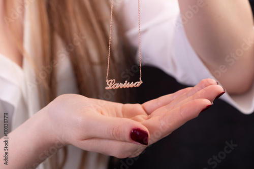 Name necklace on young woman