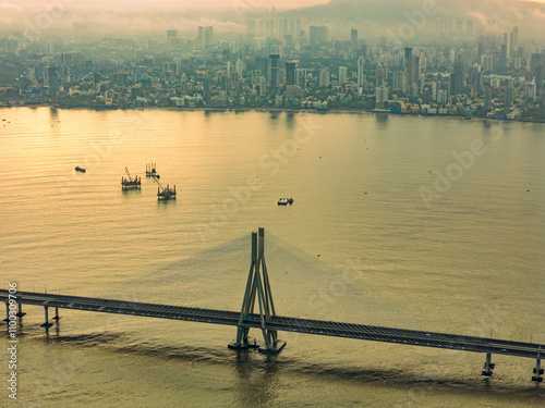 Aerial view of the beautiful Worli Sea Link bridge and bustling cityscape at sunset over the Arabian Sea, Mumbai, India. photo