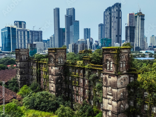 Aerial view of abandoned buildings and highrise skyscrapers surrounded by overgrown vegetation, Curry Road, Mumbai, India. photo