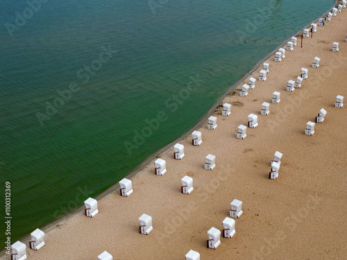 Aerial view of strandbad wannsee public beach with sandy shore and colorful umbrellas, Nikolassee, Germany. photo