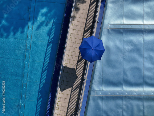 Aerial view of public pools with blue water and umbrellas in summer, Mitte, Germany. photo