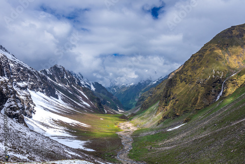 Panoramic view of glacial u-shaped valley having snow cladded peaks, glaciers and moraines  deposited by glacier enroute high altitude trek 4650m in Himachal Pradesh. photo