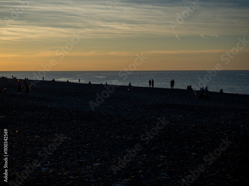  People on the seashore. People watching the sunset. Resort place. Silhouettes of people. Black Sea coast