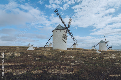 View of historic windmills under a picturesque sky, Campo de Criptana, Spain. photo