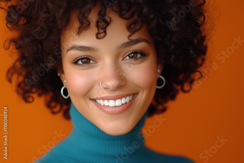 A woman with a nose ring and earrings is smiling