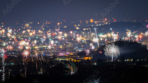 View of vibrant fireworks display over the city skyline during New Year's Eve celebration, Graz, Austria. photo