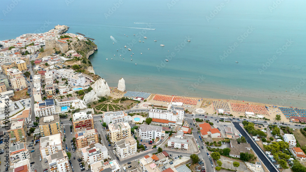Fototapeta premium Aerial view of the castle and Pizzomunno stack located in Vieste, Puglia, Italy. Beautiful panorama of this tourist destination of Gargano overlooking the Mediterranean Sea.