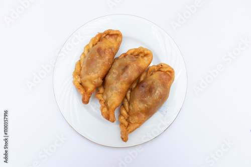 chicken vegetable puli pitha served in plate isolated on white background top view of bangladeshi food photo