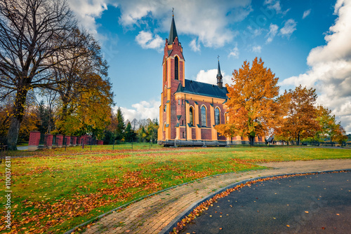 Attractive autumn view of red brick Church of St. Stanislaus the Bishop, Poland, Europe. Moddy morning scene of Lutowiska village, Bieszczady County, Subcarpathian Voivodeship of  Poland. photo