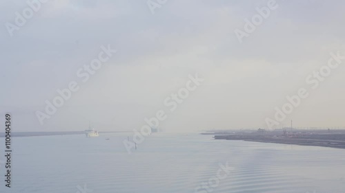 Cargo ships entering the Suez Canal lined up during fog in 2024