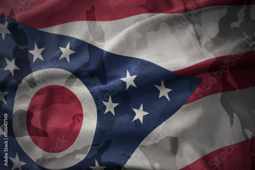 colourful waving flag of ohio state on the old army khaki texture background. military concept. photo