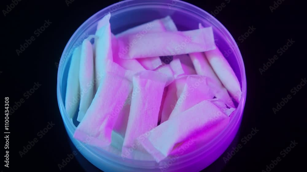 Snus nicotine tobacco close up, pack of tobacco for gum. unhealthy addiction. Man opening box with snus and taking one. 