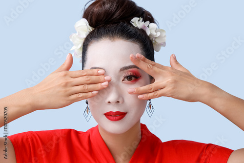 Beautiful young geisha on light background photo