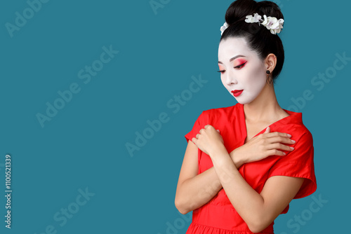 Beautiful young geisha on blue background photo