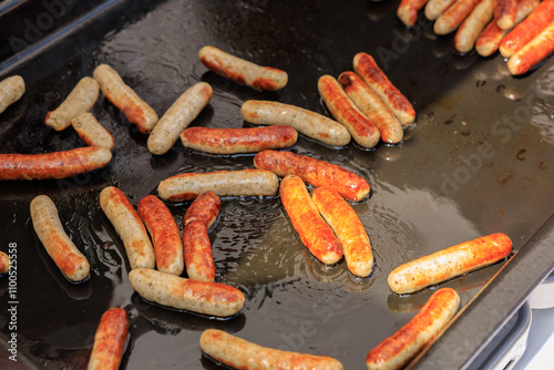 Close-Up of Grilled German Sausages on Hot Pan, Showcasing Traditional Street Food photo