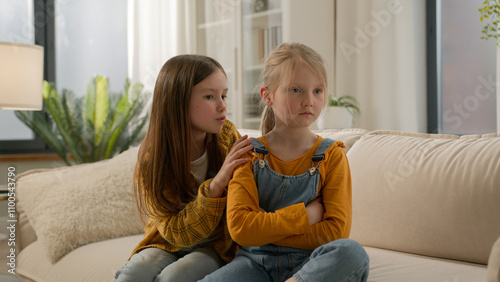 Canvas Print Two little Caucasian kids children siblings daughters girls argument remorseful