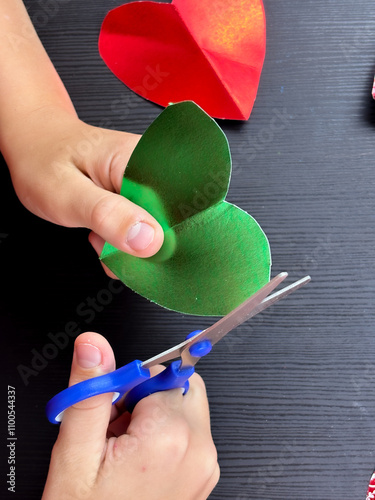 decorative hearts: child cutting out handmade valentines....... photo