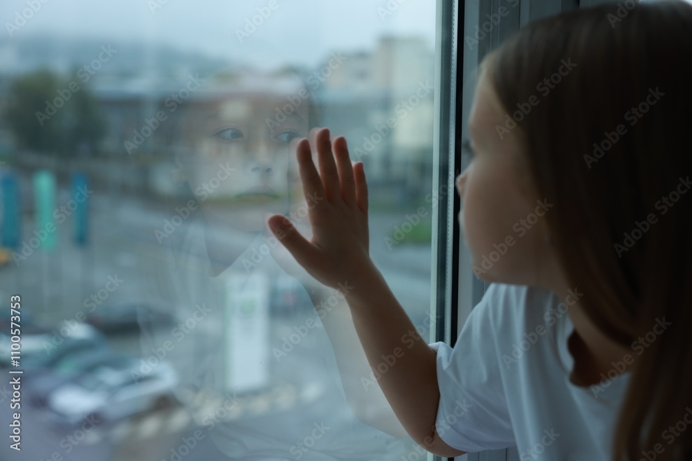 Fototapeta premium Autism concept. Lonely little girl near window at home, space for text