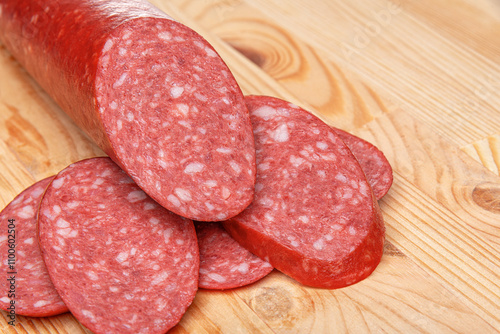 Obraz na płótnie Sausage stick on wooden background. Pork beef sausage. w salonie