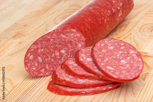 Obraz na płótnie Sausage stick on wooden background. Pork beef sausage. w salonie