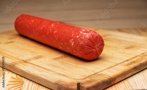 Obraz na płótnie Sausage stick on wooden background. Pork beef sausage. w salonie