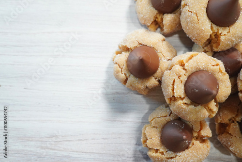 Peanut Butter Blossom cookies freshly made and ready for a cup of milk.  Baking Peanut Butter Blossom cookies for a Christmas party.