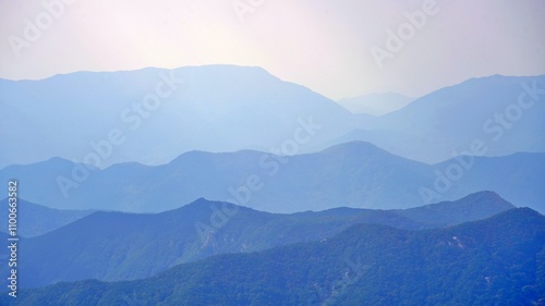 Sunlit mountain ridges around Cheonhwangsan Mountain in Miryang, Korea photo