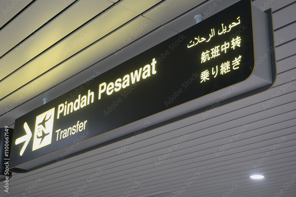 sign transfer with arrow for direction for transit passenger to change air plane for destination. yellow transfer for connecting flight sign at the airport sign transfer with arrow for direction for transit passenger to change air plane for destination. yellow transfer for connecting flight sign at the airport