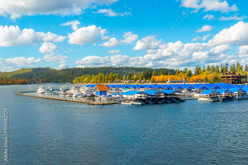 The floating boardwalk and marina with the city beach and park behind at autumn on Lake Coeur d'Alene, in Coeur d'Alene, Idaho.