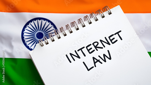 Against the background of the flag of India lies a notebook with the inscription - INTERNET LAW