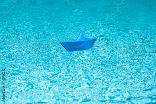 Sail boat. Tourism and traveling, travel dreams vacation holiday, sailing adventure. Traveling adventure. Summertime vacation. Paper ship and ocean water. Paper boat in water. Paper boat sailing.