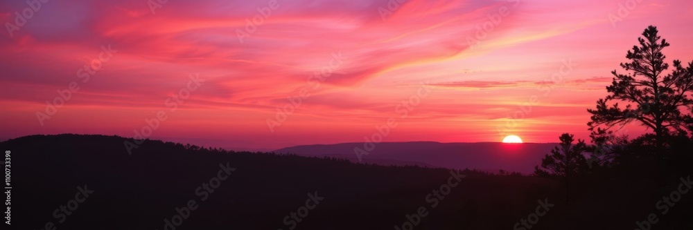 Obraz premium Vibrant gradient of orange, pink, and purple hues in a dramatic, beautiful sunset over a silhouette of a forest, beautiful, serene