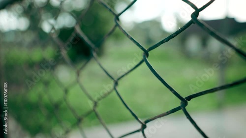 Connection Through Barriers: Represents the connection and division created by physical barriers like a fence, highlighting a balance between isolation and openness.