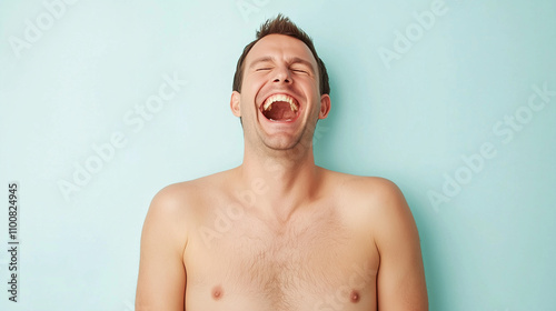 Unbridled Joy: A shirtless man throws his head back, laughing uproariously against a pastel blue background.  A portrait that captures pure, unadulterated happiness.  photo