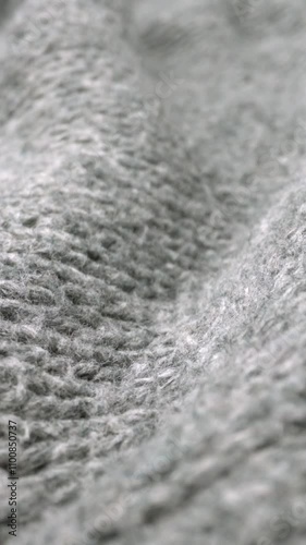 Extreme detail view of sheep wool cloth texture in macro dolly shot. Flowing animal fiber material for handcraft knitting. Textile abstract background. Winter fashion clothing industry concept. photo