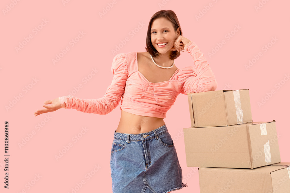 Beautiful young happy woman with many parcels on pink background Beautiful young happy woman with many parcels on pink background