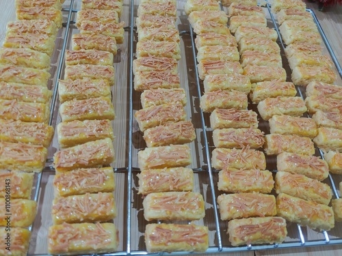 Kastengel cake on the oven rack, Kaastangels in Dutch are savory cheese tarts or cheese sticks originating from the Netherland. These cookies are popular for festive occasions like Eid Al Fitr (Eid).  photo