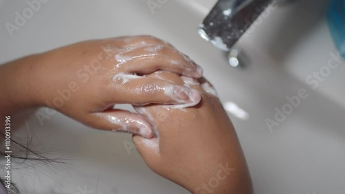 Wallpaper Mural  child making a cleansing gesture with soap and water on hands Torontodigital.ca