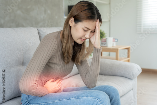 stomach ache. Asian women have abdominal pain, indigestion, gastritis, menstrual cramps, flatulence, diarrhea, distention, colon cancer, belly inflammation problem, suffer food poisoning, abdomen. photo